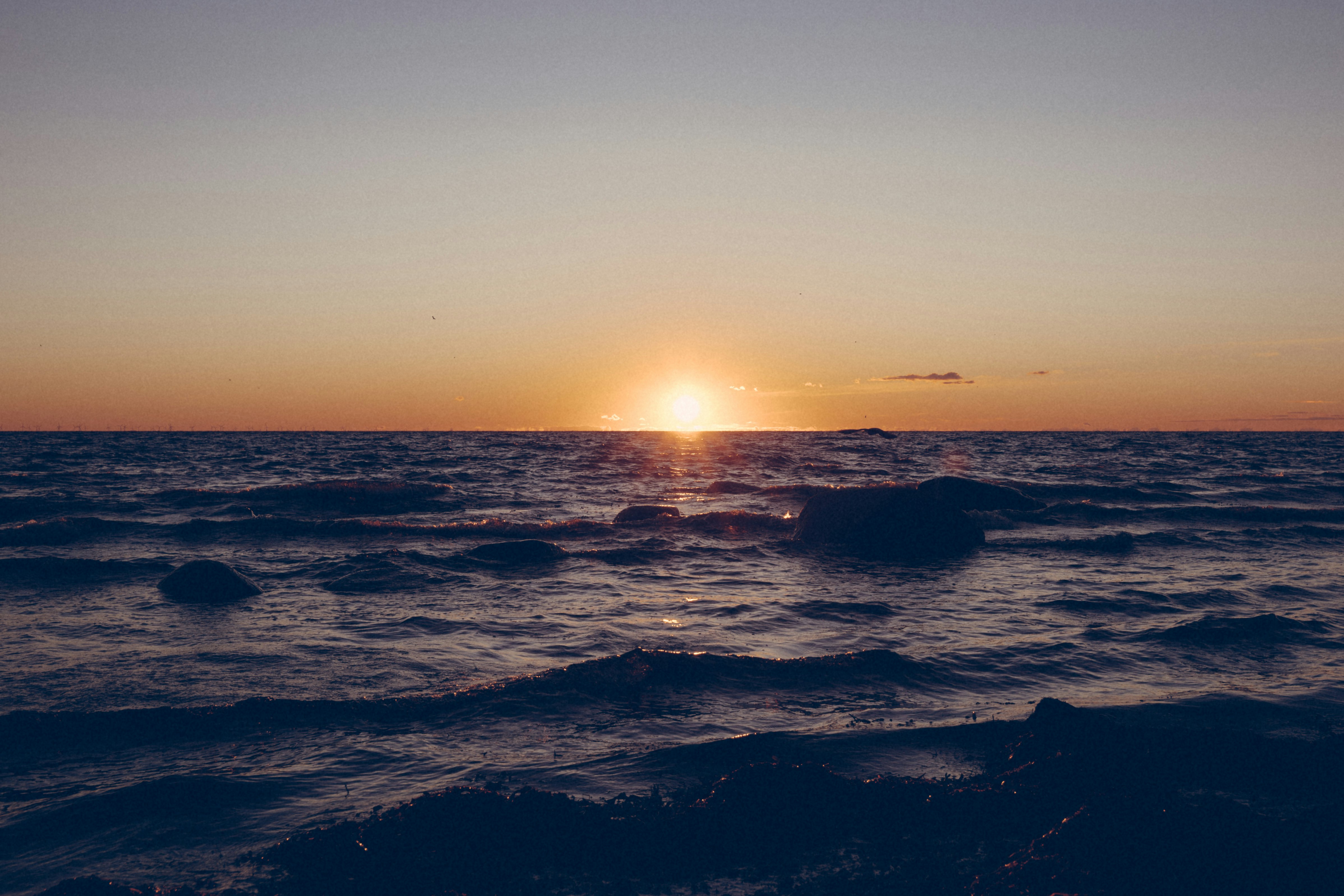 body of water during sunset